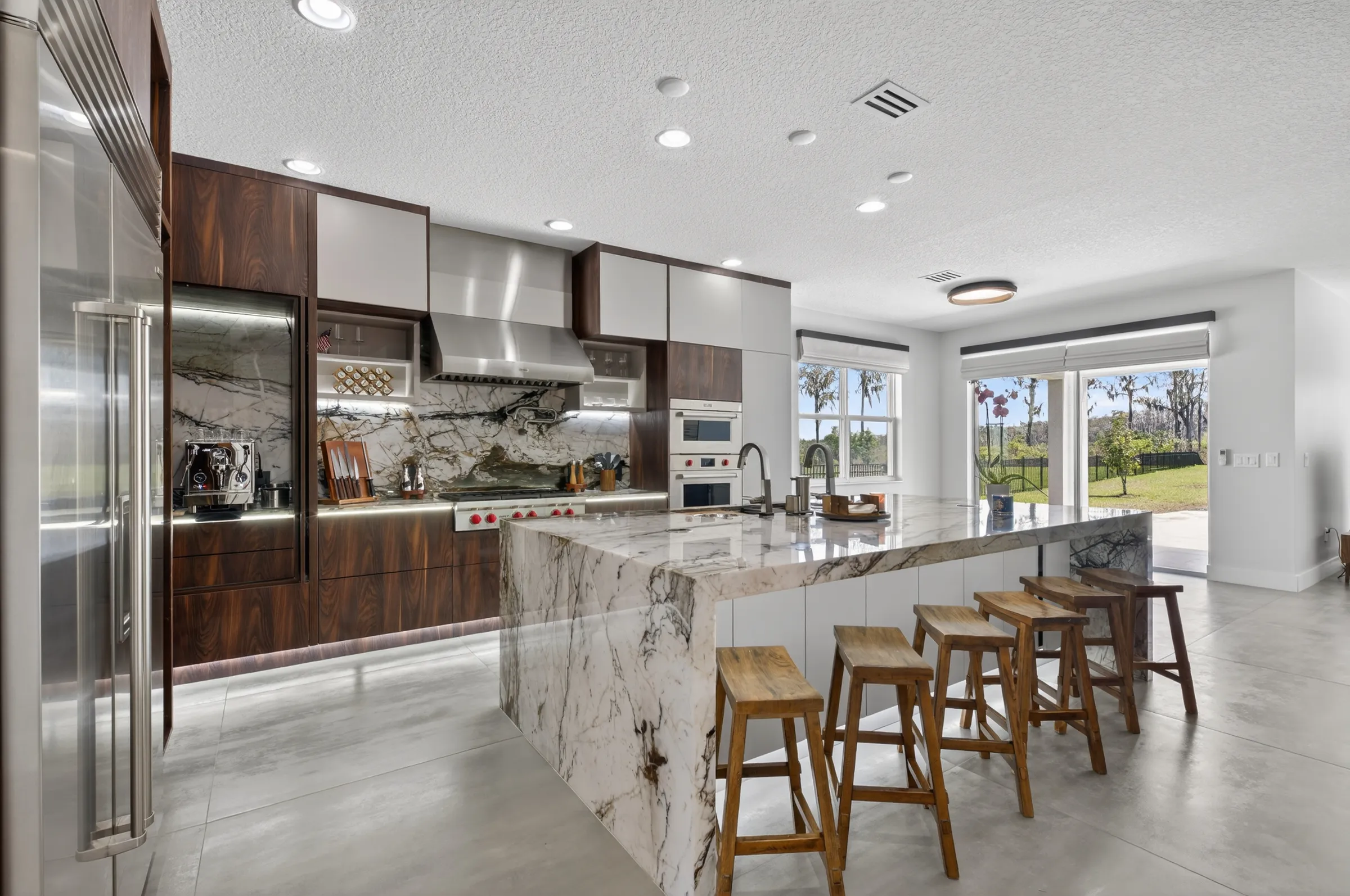 Luxury modern kitchen with marble island real estate photography by REMIX, Central Florida